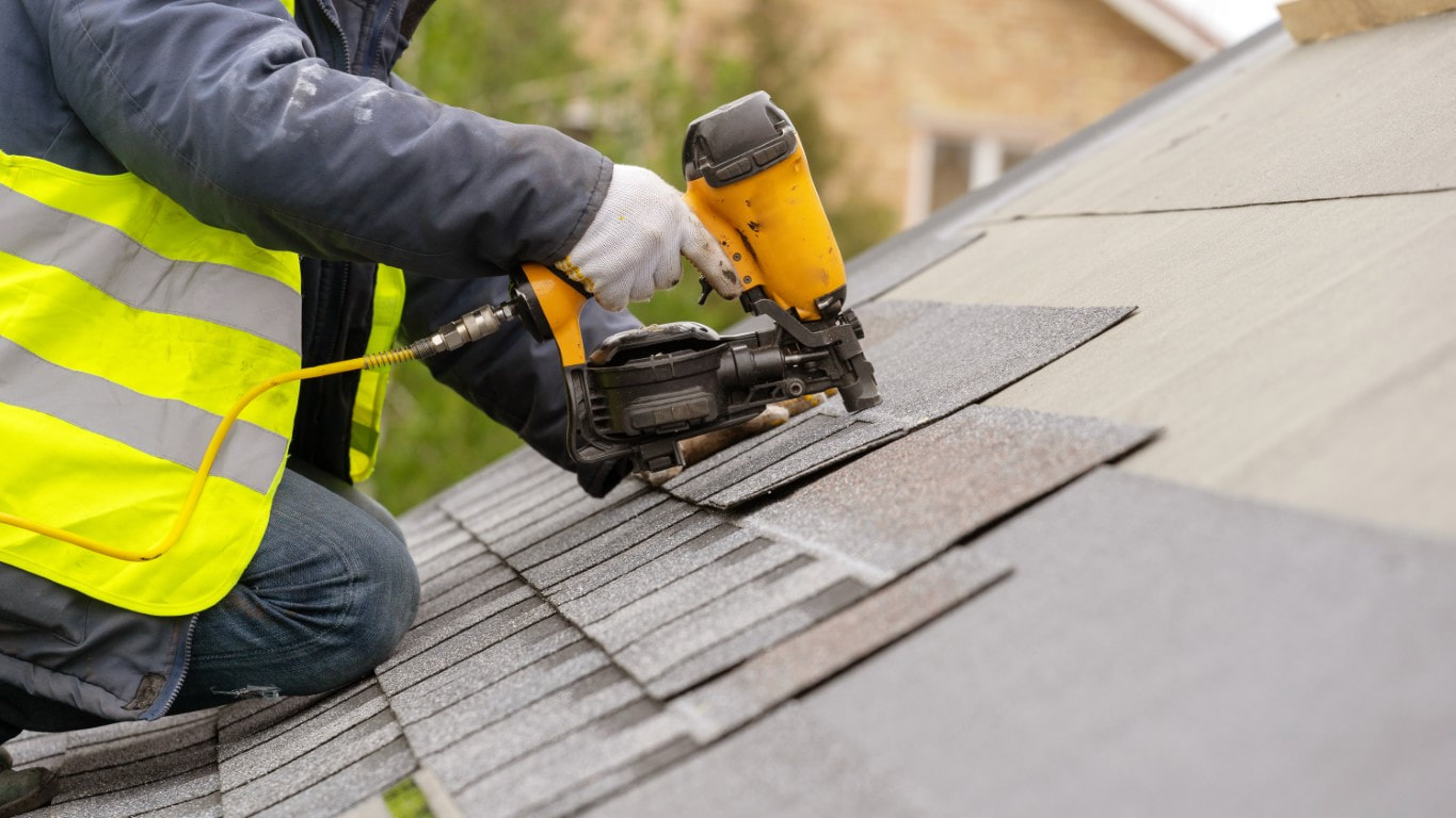 An image of a person patching roof tiles for roof leak repair