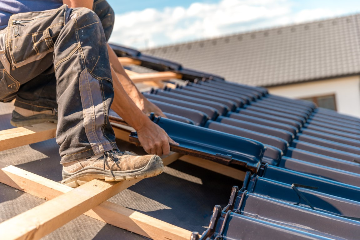 An image of a person working on a roofing service